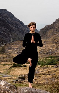 Gruop of women practicing yoga outdoors.